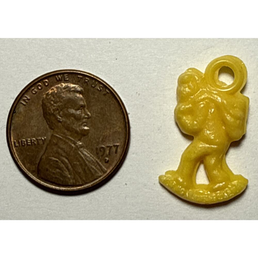 Vintage Cracker Jack Yellow Person Carrying Bag Celluloid Charm 1G